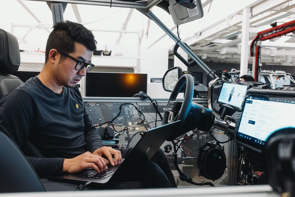 A Rivian-VW employee sits inside of one of its lab cars at its Palo Alto offices. 