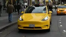 Gravity Tesla Model Y NYC yellow taxi front view