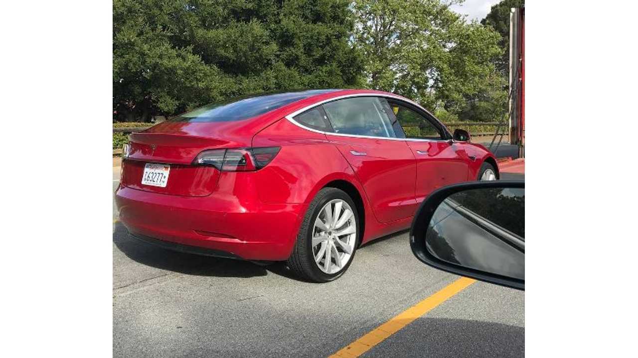 <em>Red Tesla Model 3</em>