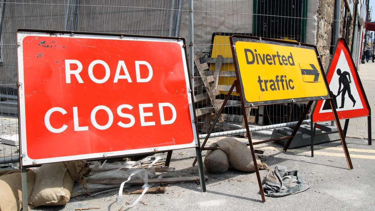 British roadworks with road closed and diverted traffic signs