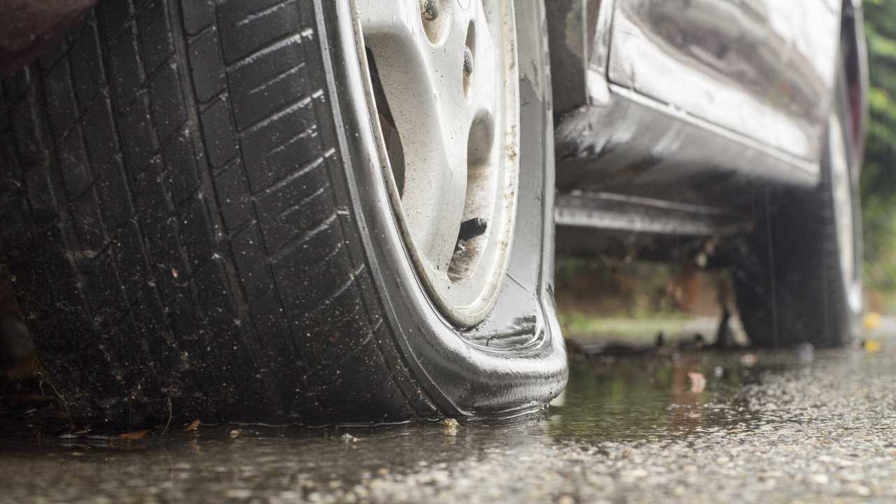Car flat tyre in rainy day