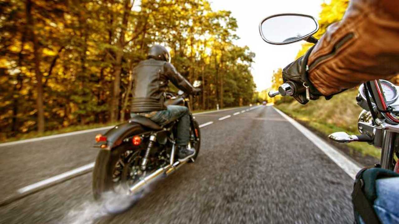 Motorcycle on the road with exhaust fumes