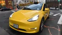 Gravity Tesla Model Y NYC yellow taxi front three-quarter view