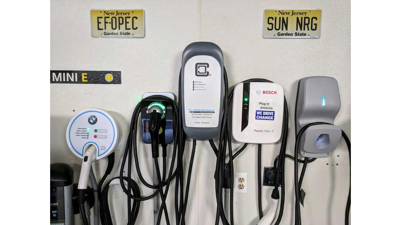 The FLO Home X5 (far right) compared to four other popular EVSEs, seen in the InsideEVs charging station testing garage