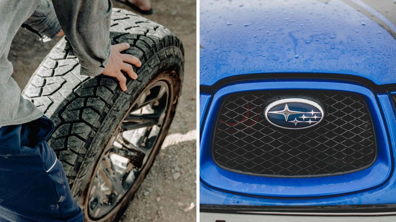 Mechanic removes tires on a Subaru