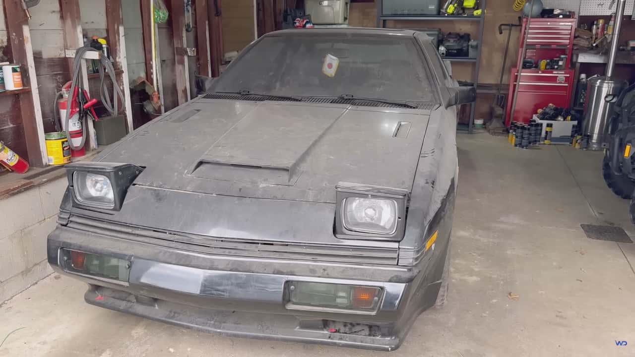 1987 Mitsubishi Starion in a garage covered in a thick layer of dust