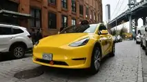 Gravity Tesla Model Y NYC yellow taxi front three-quarter view
