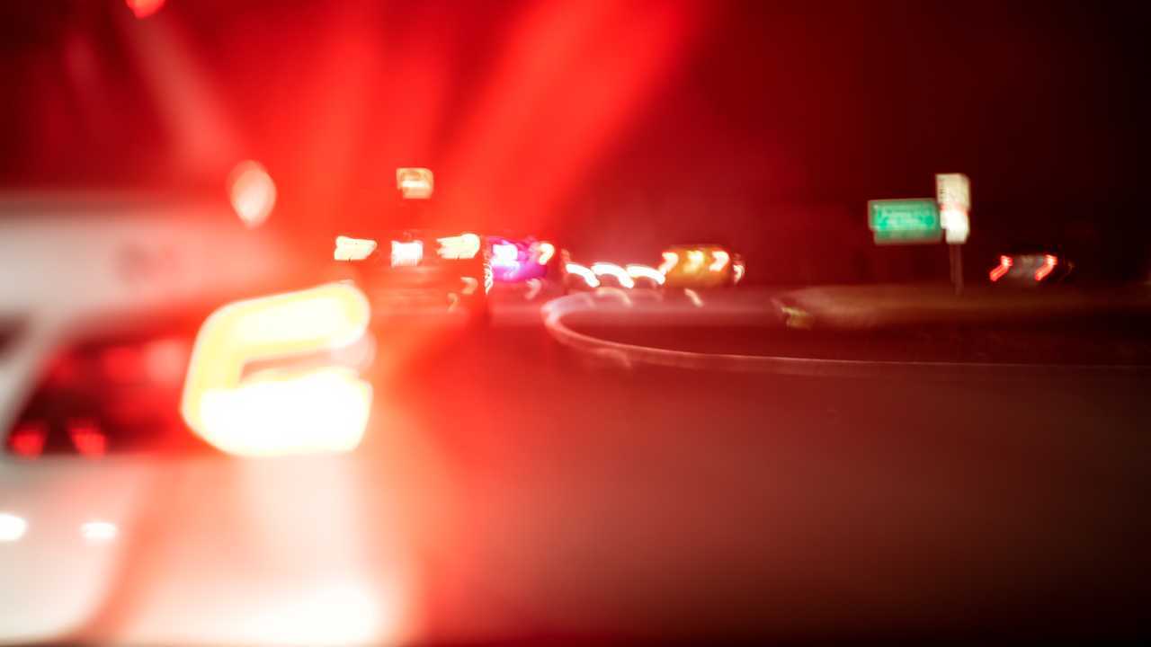 Closeup of bright red brake lights in traffic at night