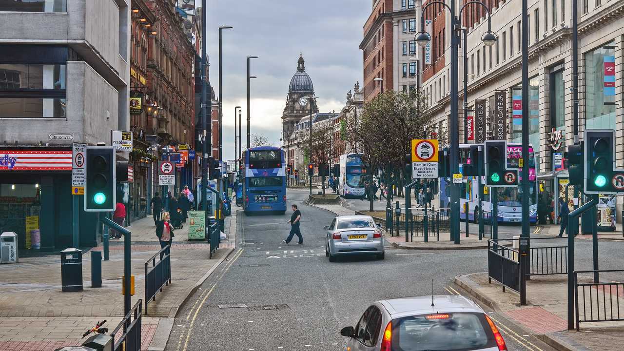 Traffic and people at Leeds city centre UK