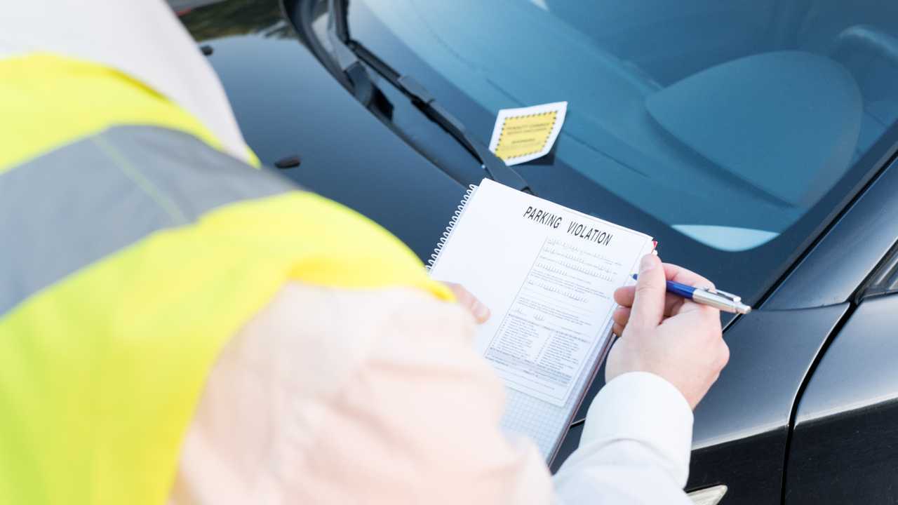 Officer giving a ticket fine for parking violation