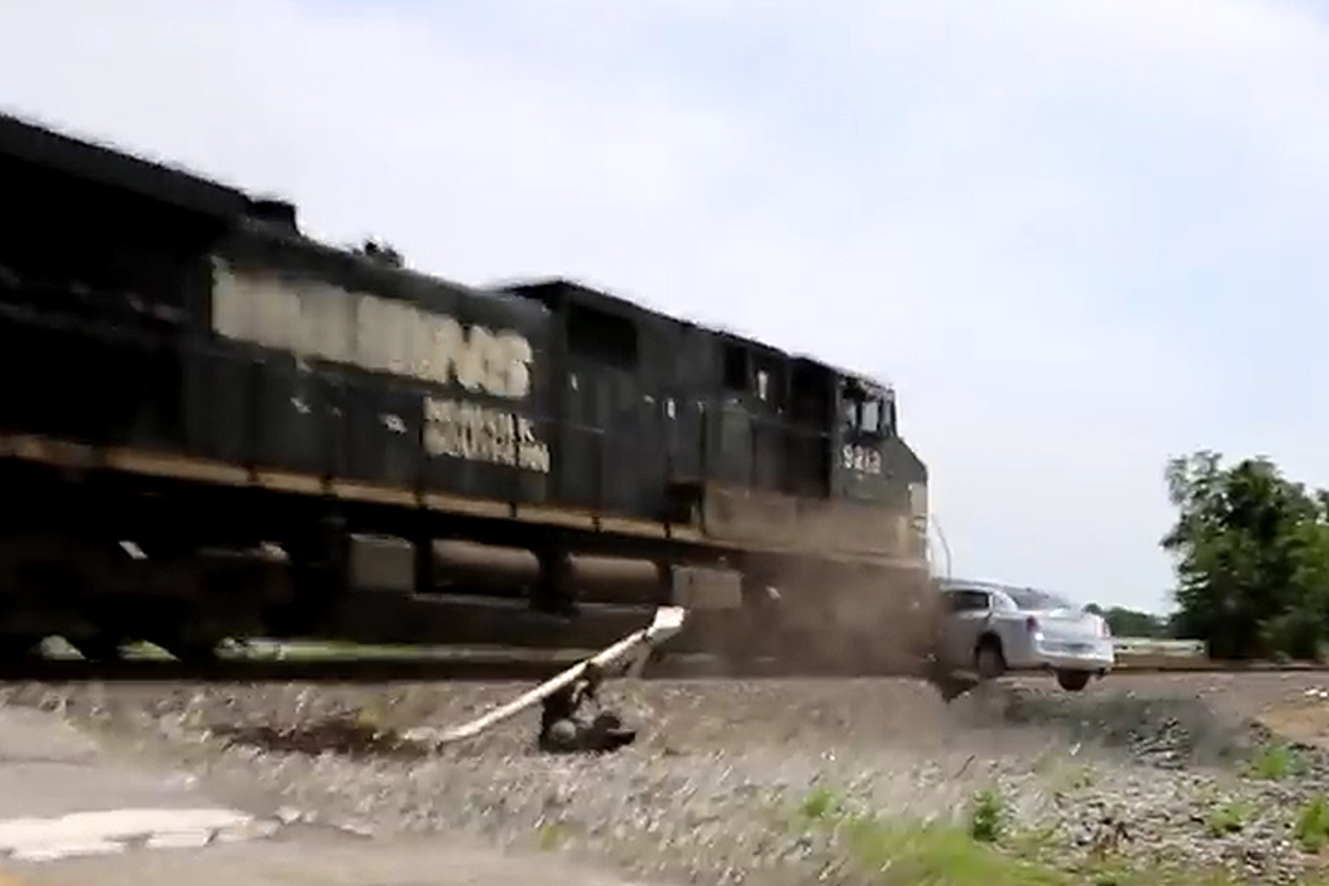 See Train Barrel into Limousine Stuck on the Tracks