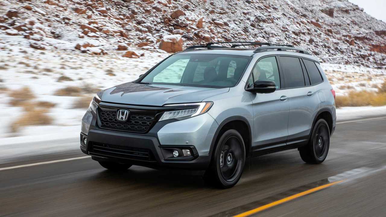 Side view of a silver Honda Passport SUV. 