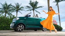 Wuling Hong Guang Mini EV Cabrio exterior with woman posing alongside