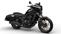 Honda CMX1100T Rebel 2024, Studio, negro plomizo metalizado con ruedas de bronce, vista delantera en ángulo derecho