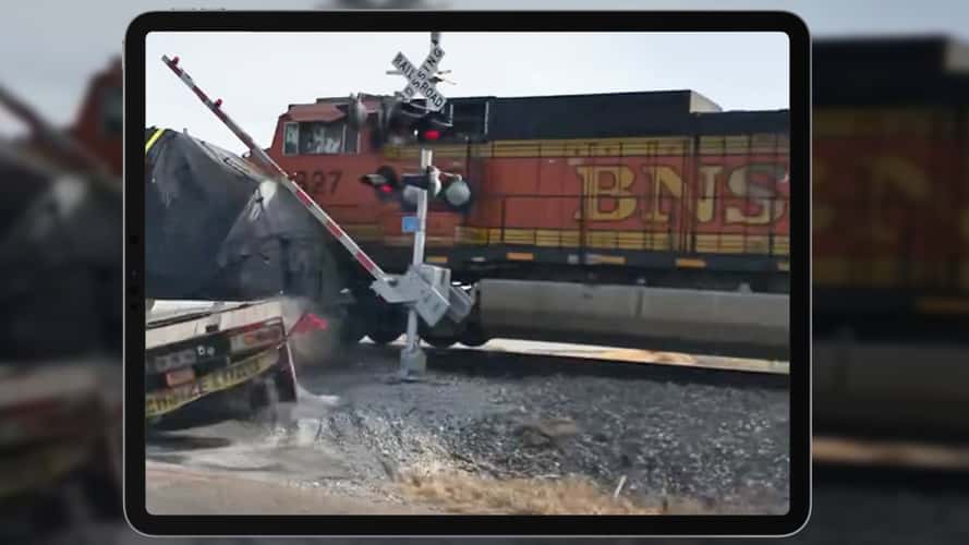 Video: Train crashes, derails after hitting semi-truck stuck on crossing