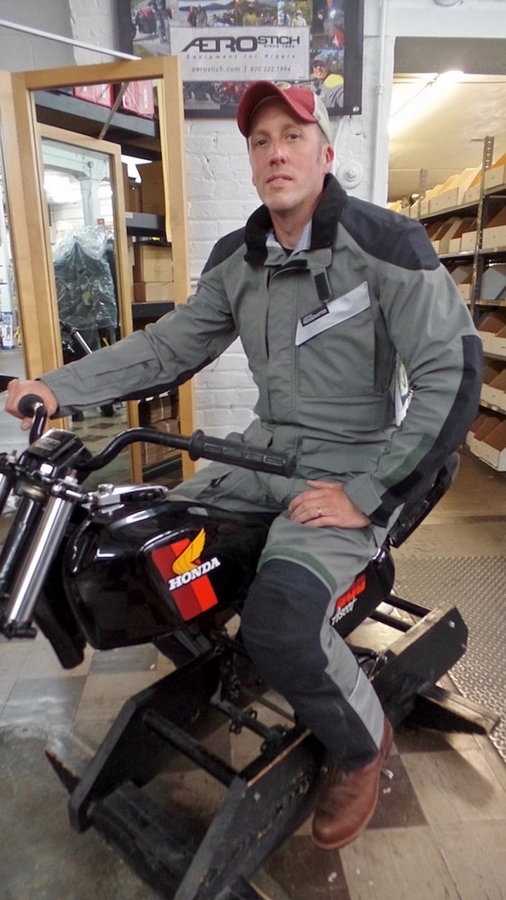 <em>That's me rocking my R3. With that and my Red Wing boots (and the fact I had ridden up to Duluth on an Indian Springfield) I was feeling pretty Minnesota. I'm sitting on a hobby-horse-esque set-up that Aerostich uses to help people get a realistic sense of what the suit will feel like on a bike.</em>