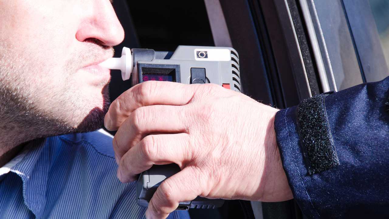 Driver is given breathalyser test by policeman