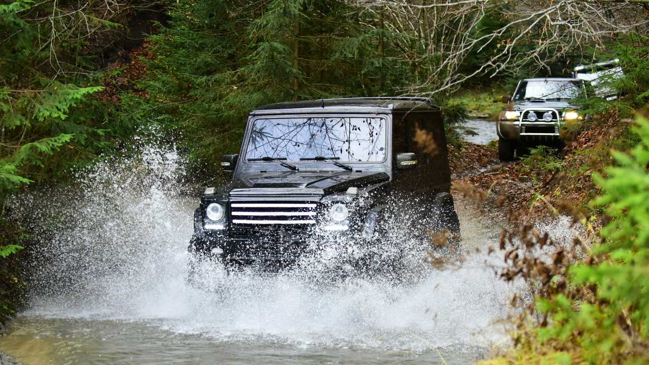 Extreme driving with SUVs or offroad cars crossing stream