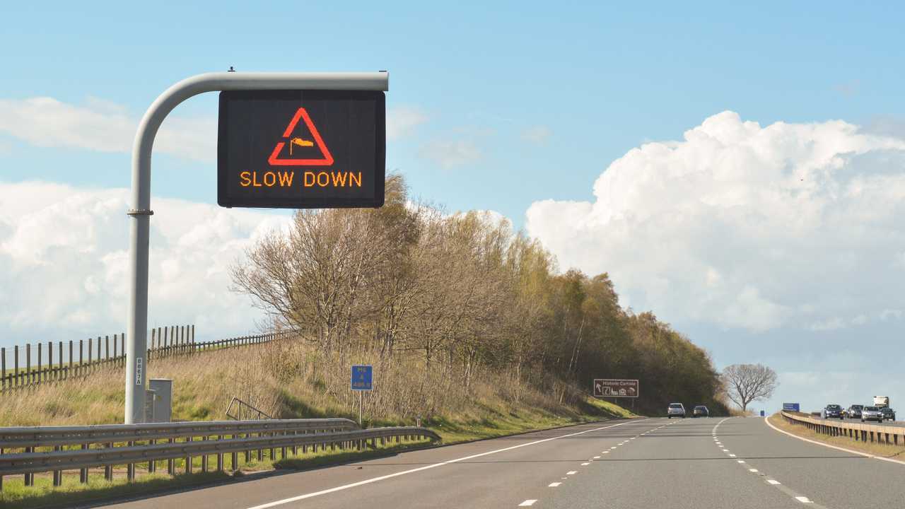 Slow down side wind traffic warning sign in Carlisle Cumbria England