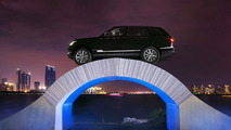 Range Rover driving over a paper bridge