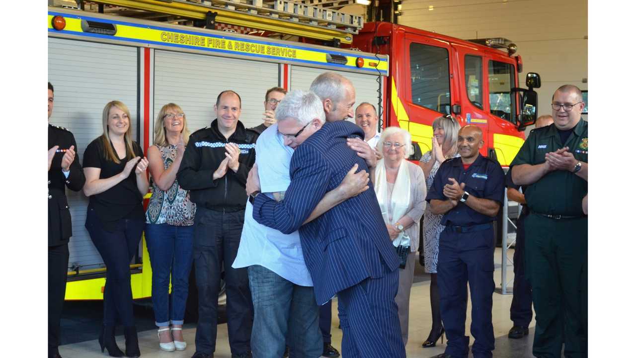 Dr. Forrest and John O'Brien hug at award ceremony