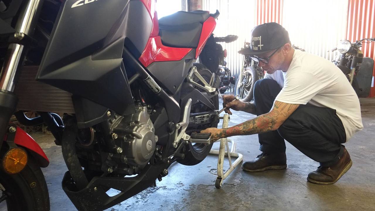 Blake at Moto Classic Garage giving the CB300F a quick chain tightening and tire check.