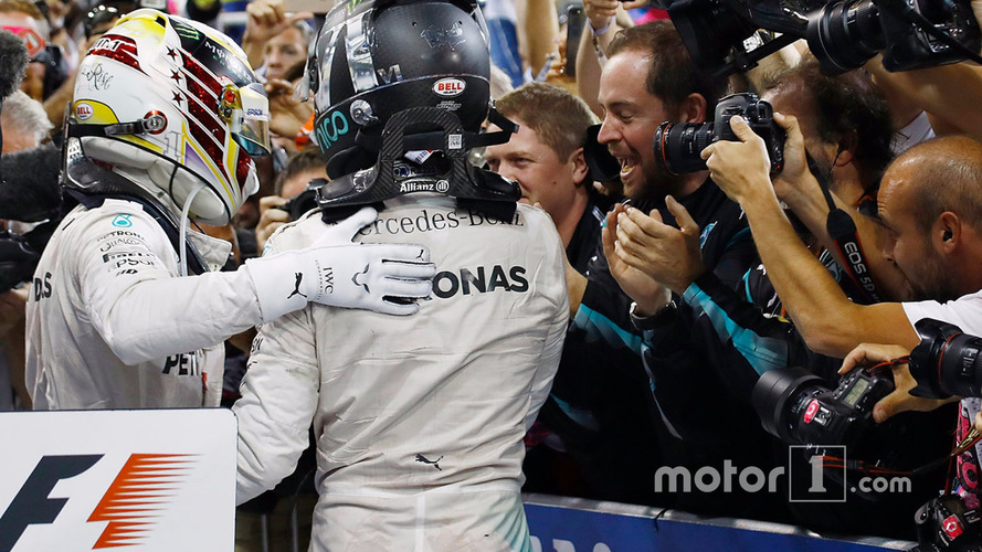Nico Rosberg, Mercedes AMG F1, celebrates in Parc Ferme after finishing in second position and winning the championship with team mate Lewis Hamilton, Mercedes AMG F1