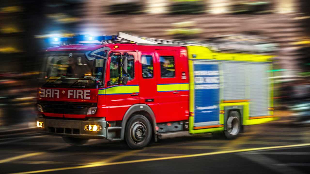 Fire engine truck speeding through city streets at night