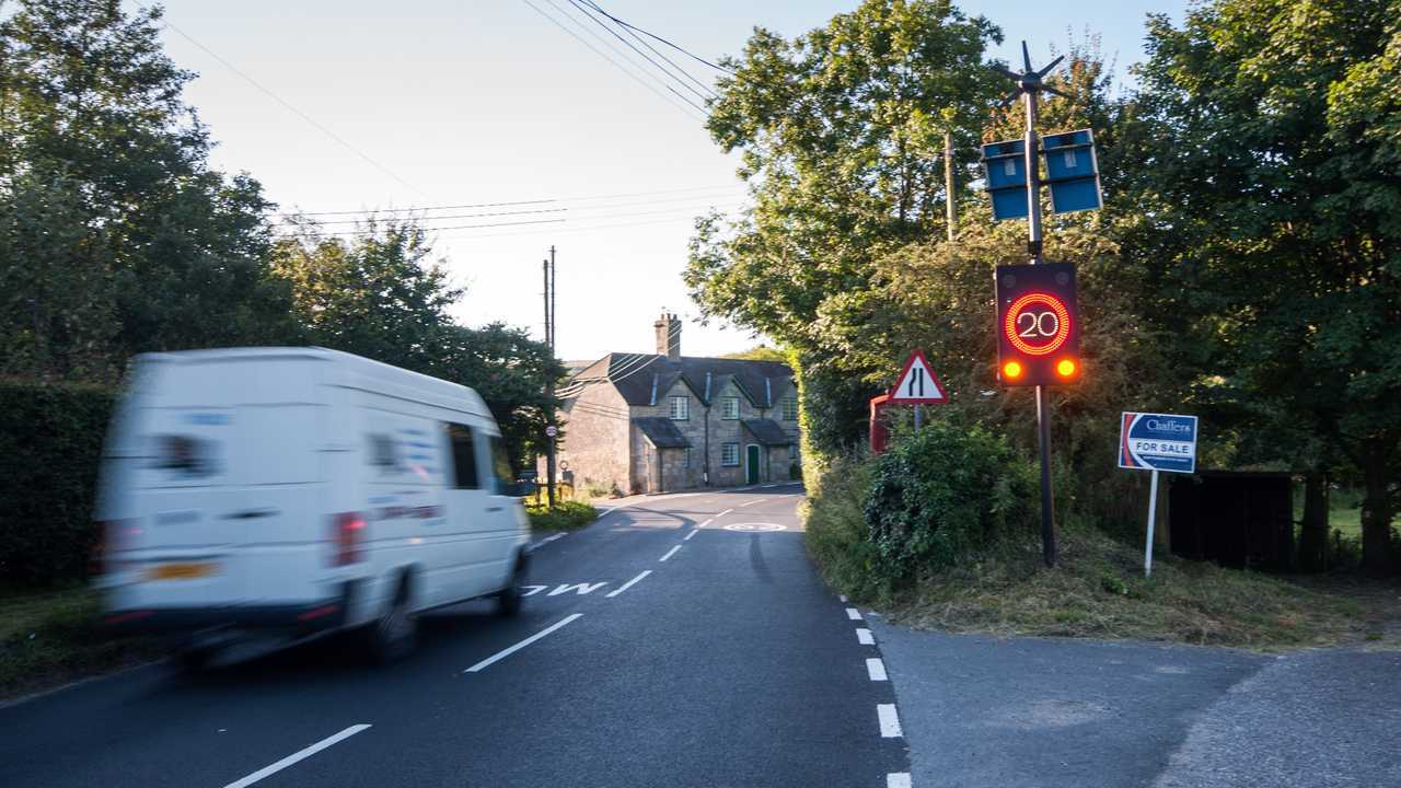 Van in Melbury Abbas village Dorset activates electronic speed limit sign