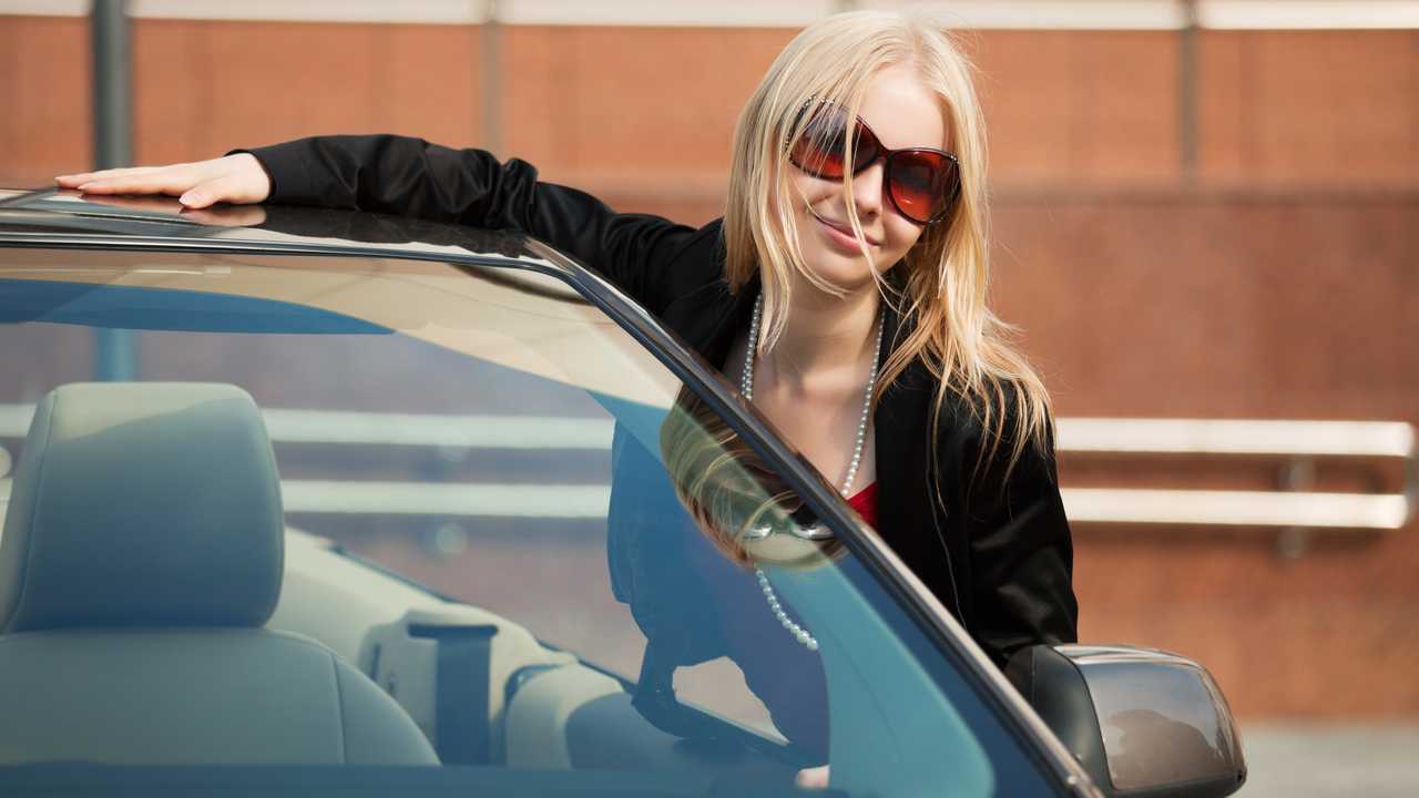 Young woman with a new convertible