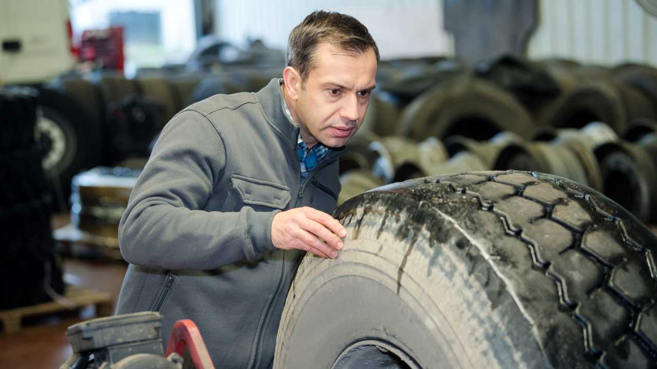 Mechanic inspecting HGV tyre