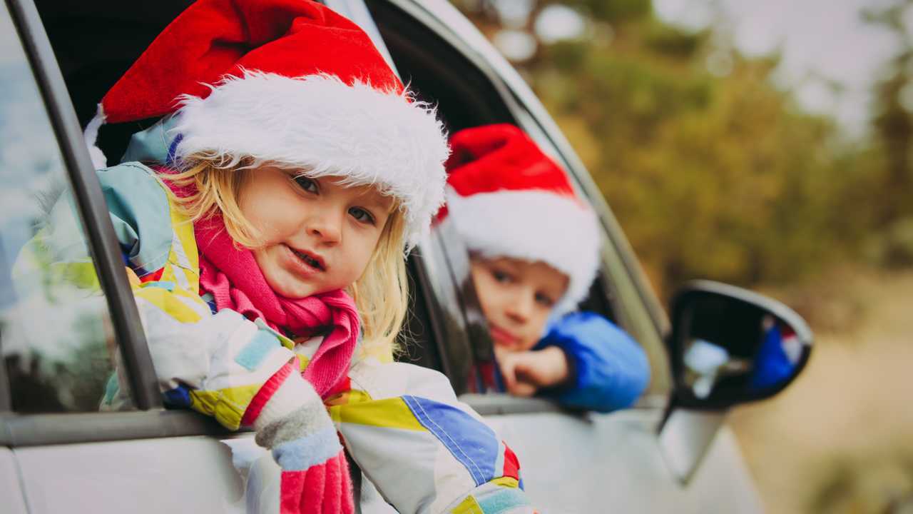 Winter driving with kids in car wearing Christmas hats