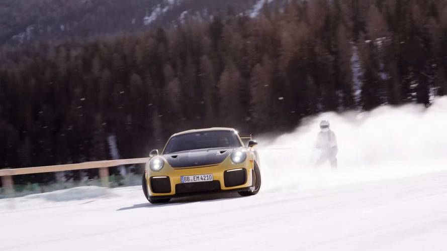 Porsche pulling skiers on frozen lake