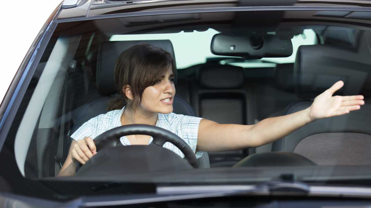 Angry woman driving in car