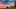 Camping caravans and cars parked under beautiful sunset