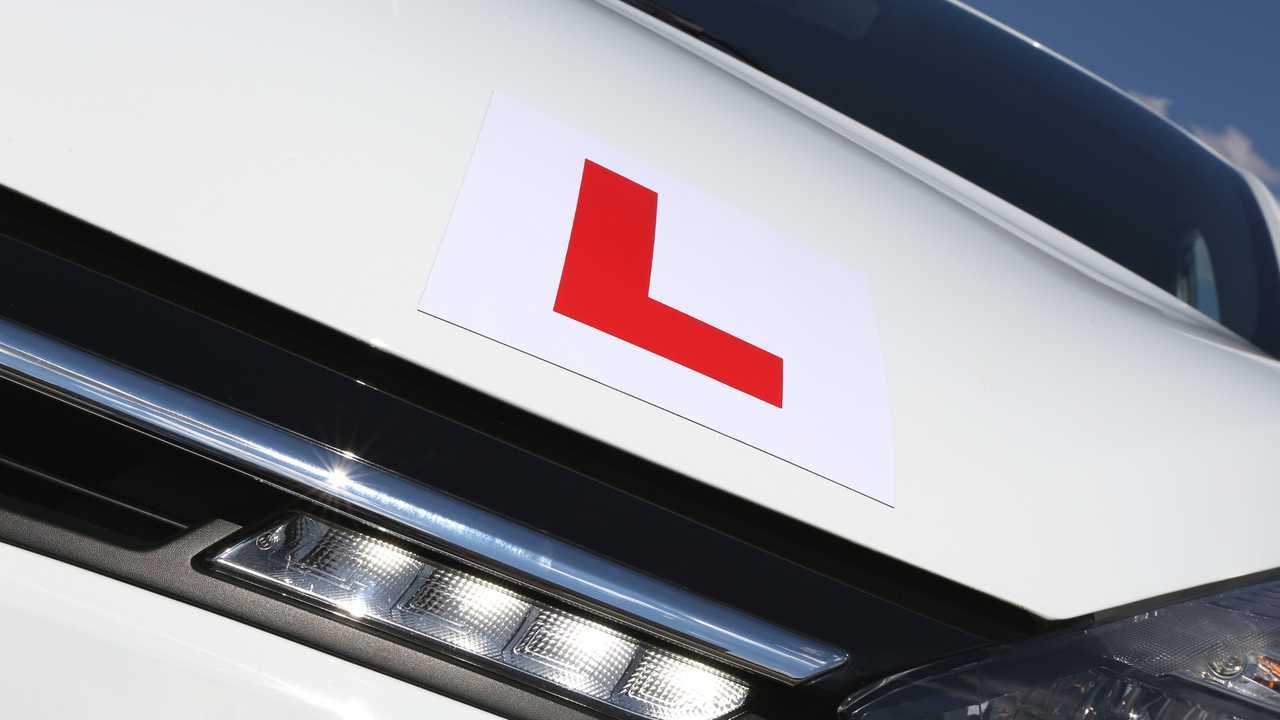 Magnetic British L-plate affixed to the front of a white car