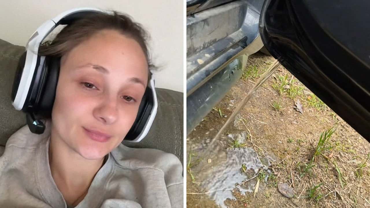 Woman Opens Door To Toyota Corolla.