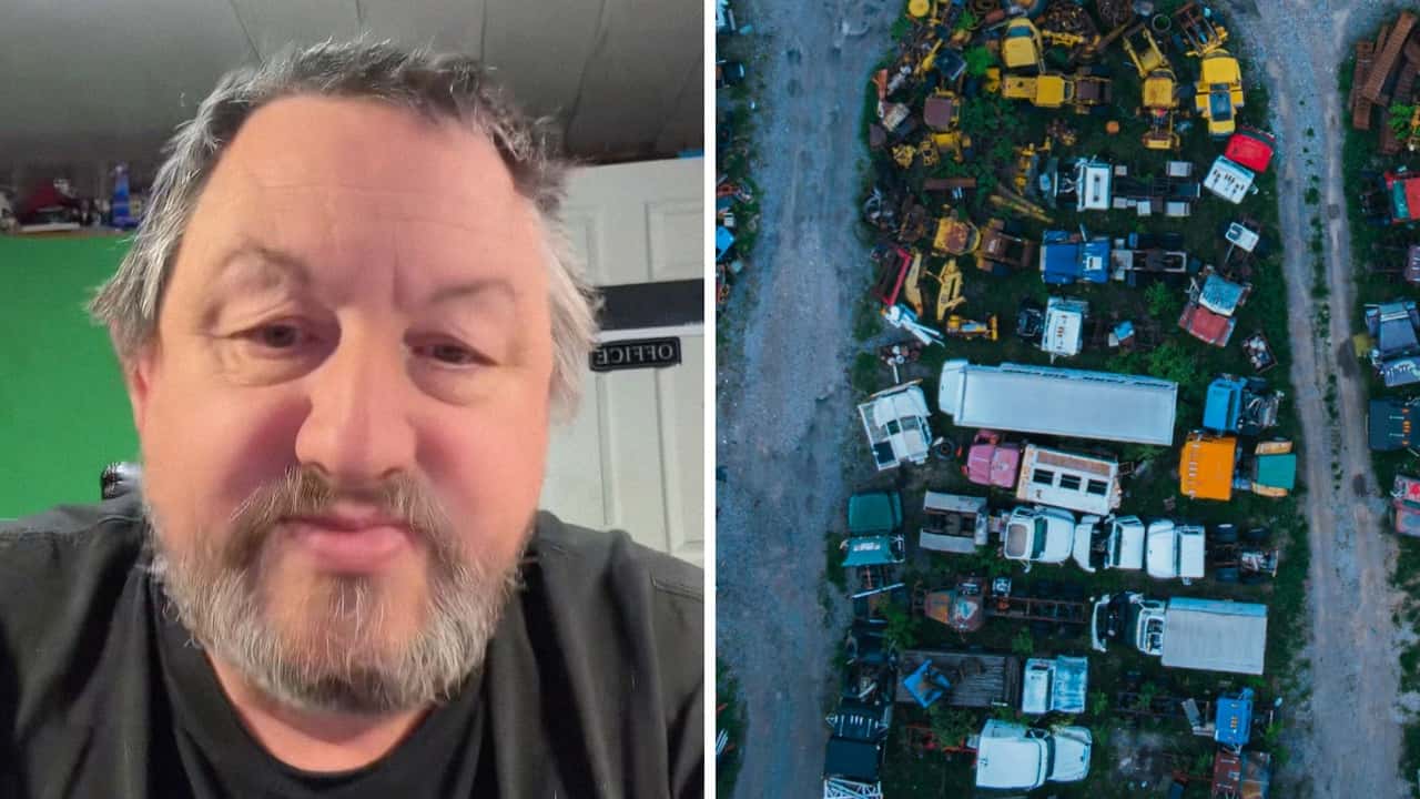  Mechanic installs replacement transmission from salvage yard.
