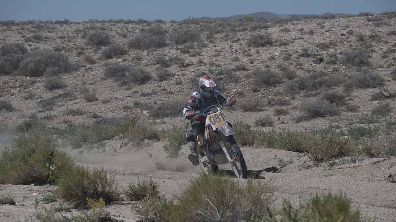 This motorcycle rider shows us a little style while railing a corner in the desert.