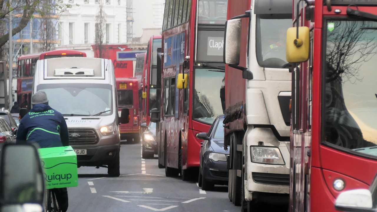 Heavy traffic with buses and vans in London UK