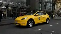 Gravity Tesla Model Y NYC yellow taxi front three-quarter view