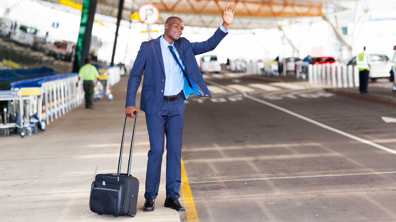 Businessman calling taxi at airport