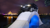Range Rover driving over a paper bridge