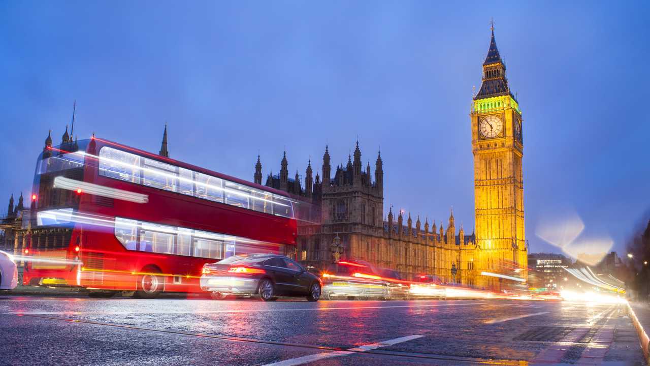 Big Ben in London city night scene with traffic