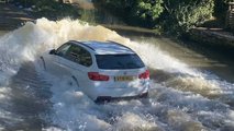 BMW 3 Series going through deep water