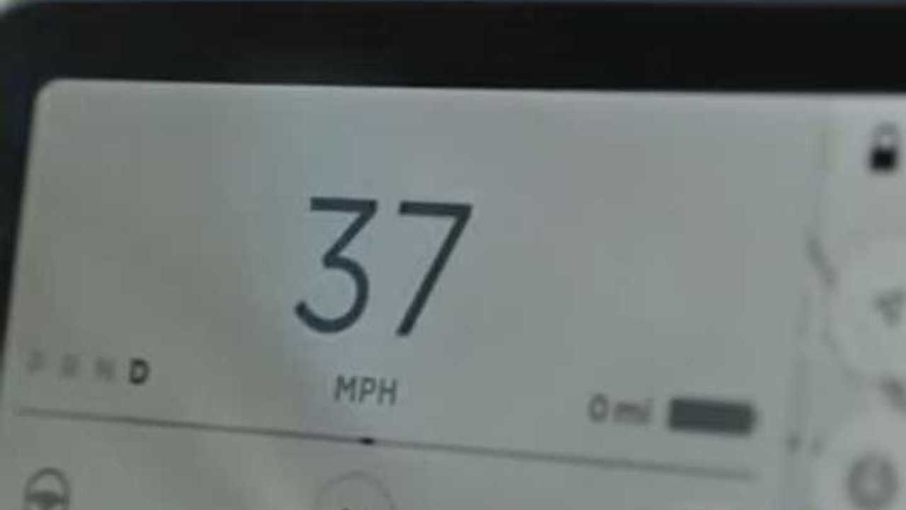 The Tesla Model 3 screen shows zero miles.