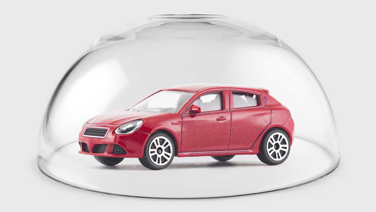 Red car protected under a glass dome