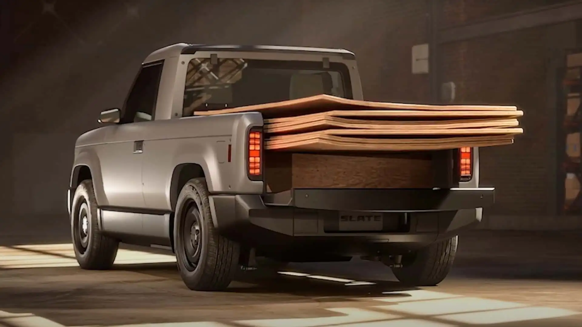 https://cdn.motor1.com/images/mgl/NGKxv2/s1/slate-truck-exterior-rear-carrying-plywood-sheets.webp