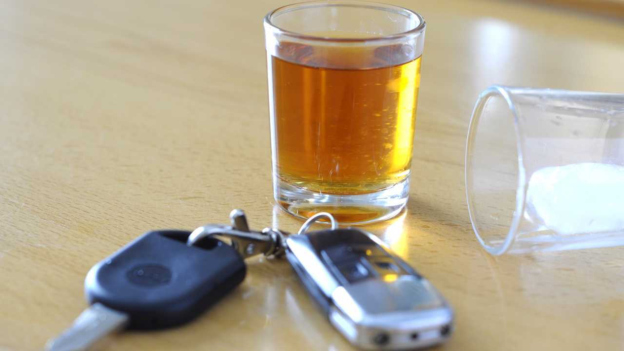 Alcoholic drink and car keys on table