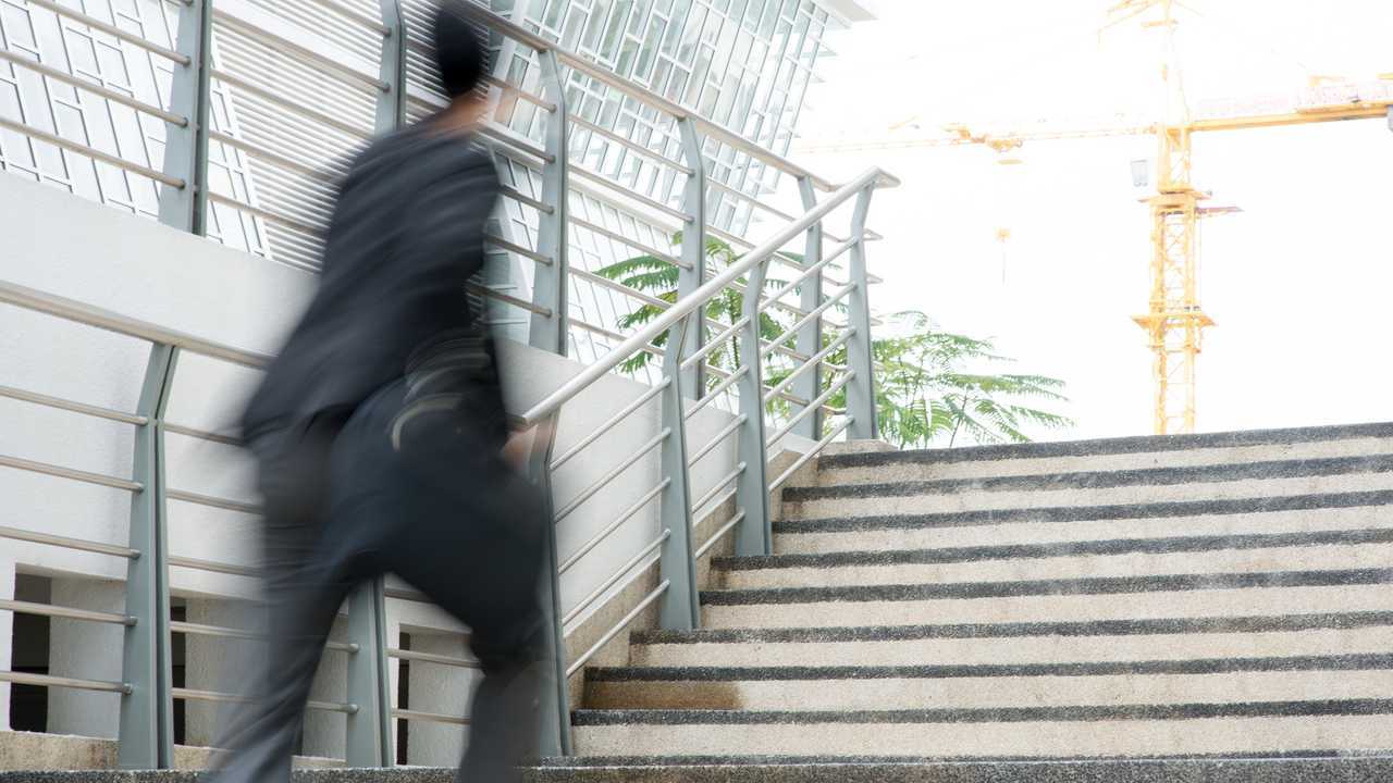Businessman in a hurry walking through office building